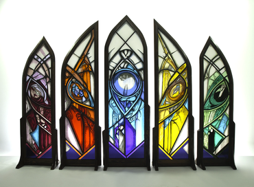 Colorful stained glass panels with intricate geometric and eye designs.