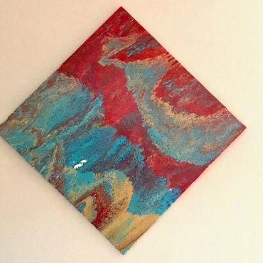 Acrylic pour with reds, turqoise and gold.