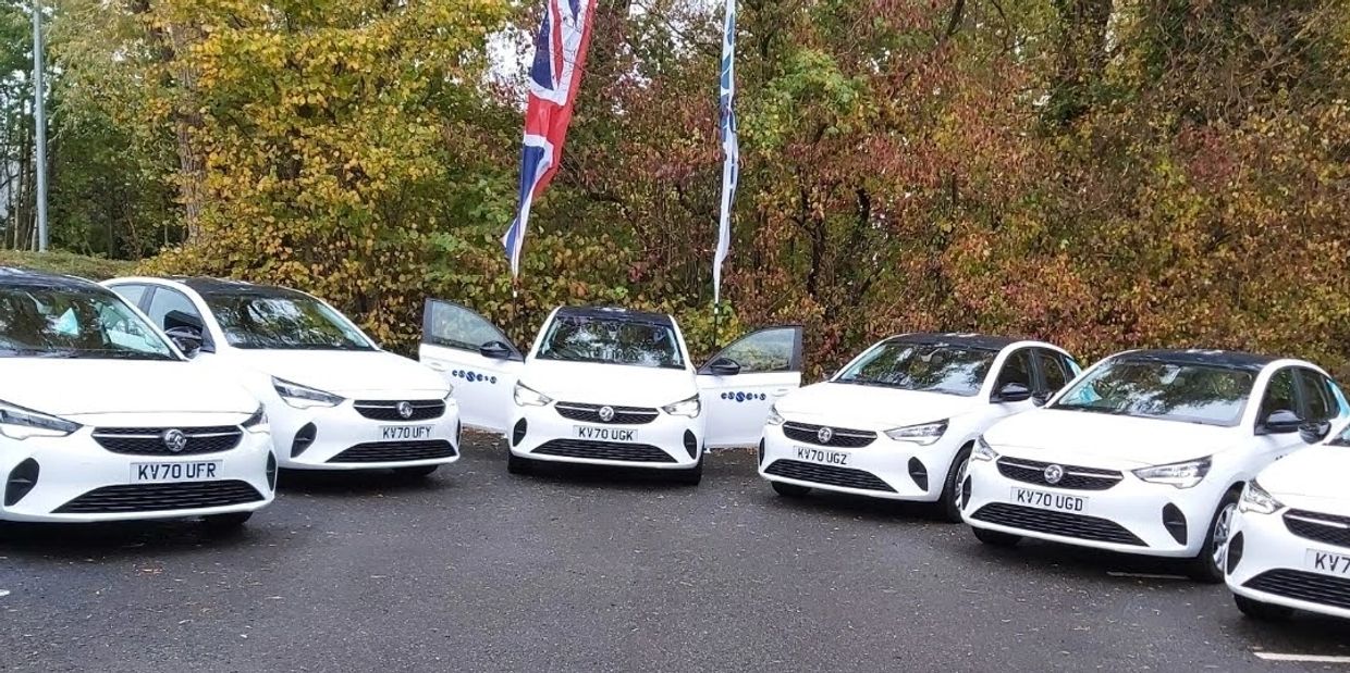 Essens Vauxhall Corsas arranged in a semi-circle ready to be collected by car programme qualifiers