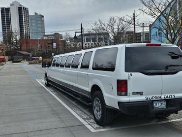 A limousine with the city in the background.
