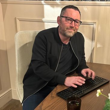 Shawn Gascoigne sitting at a desk typing on a keyboard