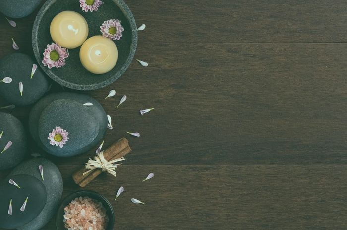 Relaxing candles, bath salts, and flower petals