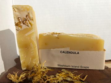 Calendula natural soap bar. It has a soft muted yellow colour.