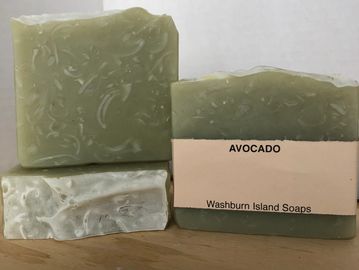 Avocado natural soap bar. It has a muted yellowish green colour with a  transparent texture on it.
