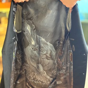 Inner lining of a coat with a detailed horse design.
