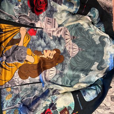 Colorful jacket featuring a Beauty and the Beast design with Belle and the Beast.