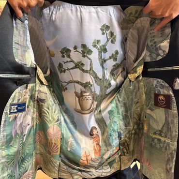 Inside of a blazer with a colorful, nature-themed mural featuring a tree, pottery, and a person.