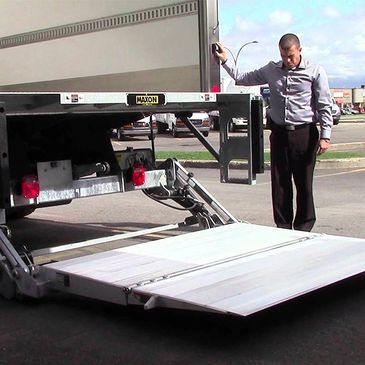 A man lifting a part of a truck with switch