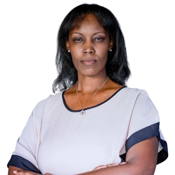 Confident woman with arms crossed, wearing a light blouse with black trim.