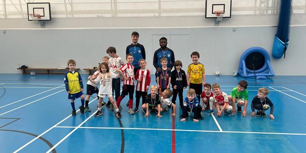 Group photo of children and coaches at a KBMultiSport multi-sport session, highlighting teamwork, inclusivity, and the fun environment of our sports camps and after-school clubs.