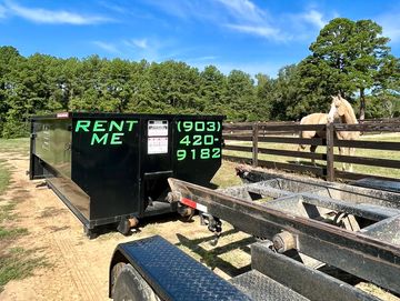 17 cubic yard roll off dumpster rental in pasture with fenced in horse