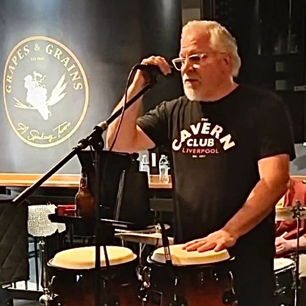 Darold Dumond singing and playing Congas.