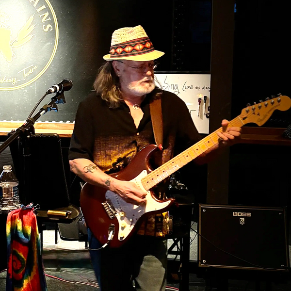 Eddie playing an electric guitar for a gig.