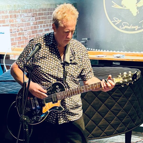 Don paying his guitar