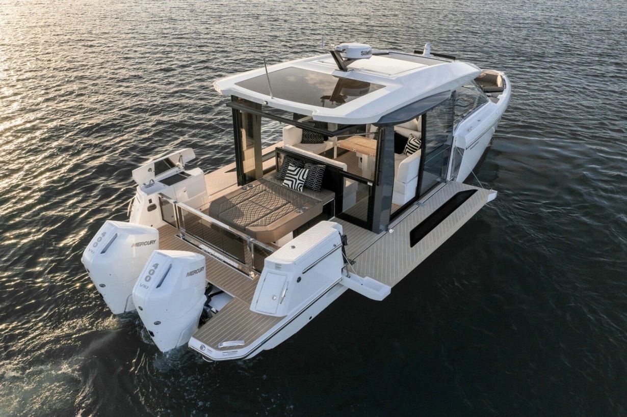 Modern luxury boat with twin Mercury engines on calm water.