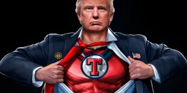 A man revealing a superhero suit with a 'T' emblem under his clothes.