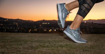 Gray Nike running shoes in action
