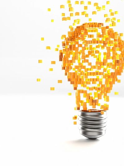 Light bulb made of orange cubes dissolving.