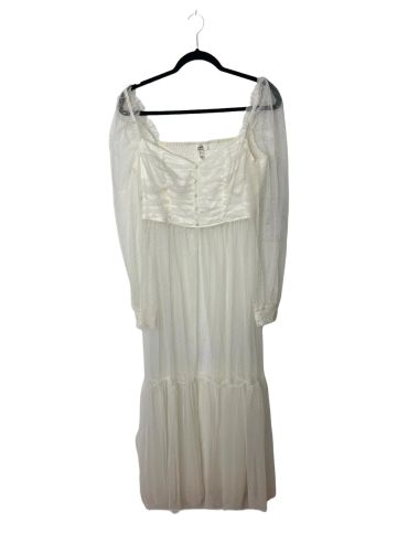 Elegant white long dress with sheer puff sleeves and buttoned bodice.