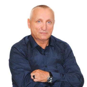 Portrait of a mature man in a dark striped shirt with a watch and ring.