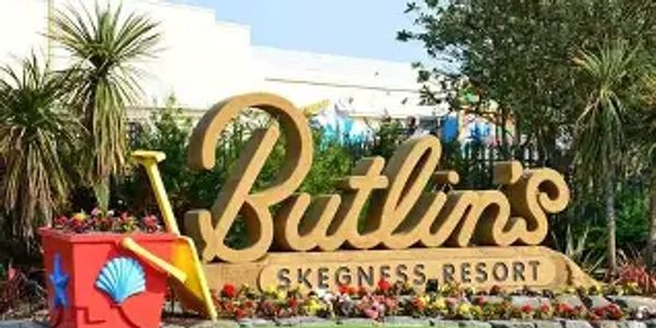Entrance sign of Butlin's Skegness Resort with plants and decorations.