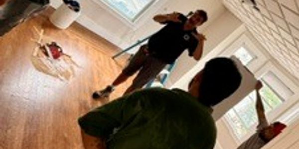 People preparing for a photo shoot in a room.