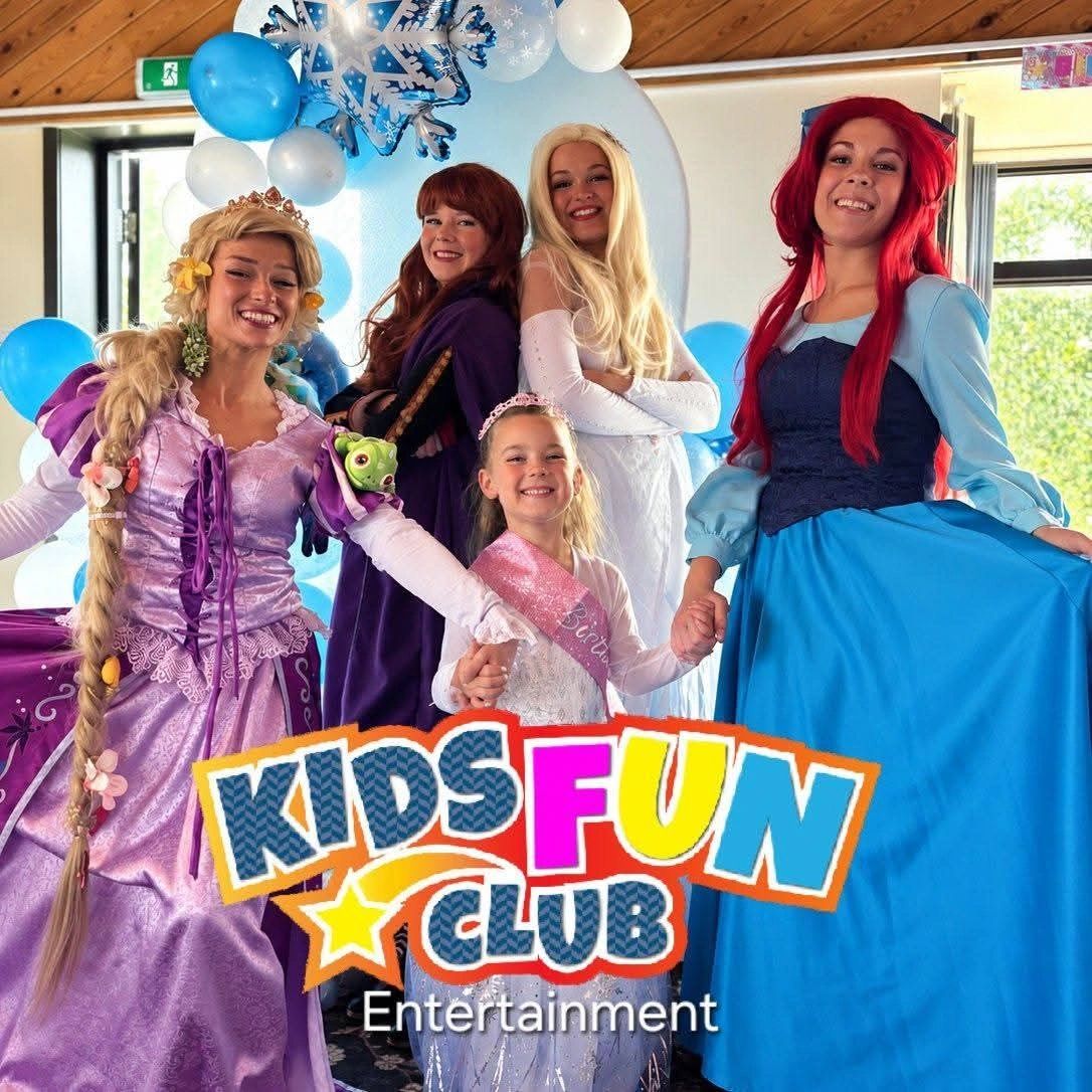 Women and a girl in princess costumes at a kids entertainment event.