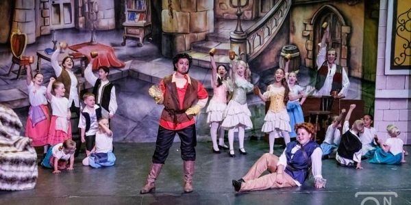 Theatrical performance with actors in medieval costumes.