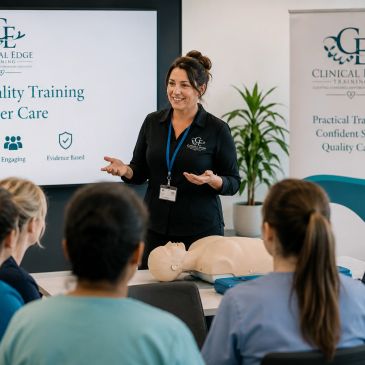 Instructor leading a clinical training session with a CPR dummy.