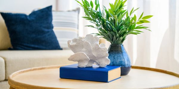 living room area, couch and a coffee table with a book and decor