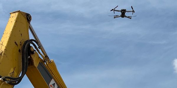 DJI Air 2S above a JCB on a demolition site. 