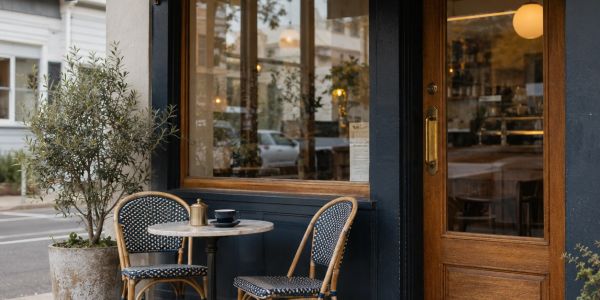 Cozy outdoor cafe seating with two chairs and a table.
