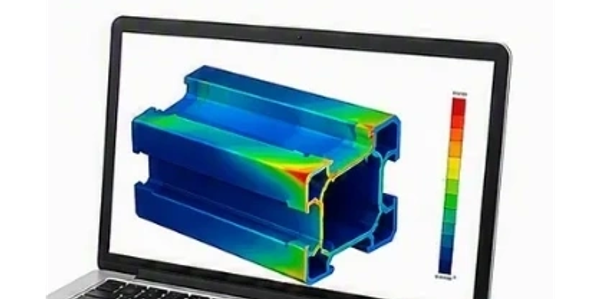 Laptop displaying a mechanical stress analysis visualization of an extrusion.