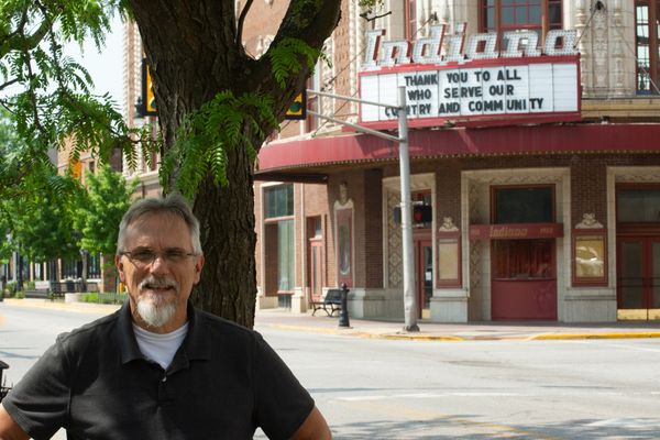 Steve Cannon standing by a tree with Indiana theater in the background.