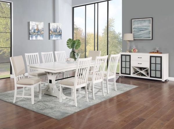 Bright dining room with white furniture and large windows.