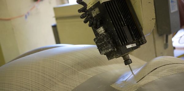 5 axis CNC trimming large thermoformed and Silkcreened part. High volume production manufacturing