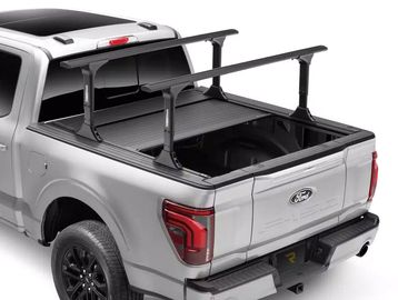 Silver pickup truck with an adjustable roof rack on its bed.