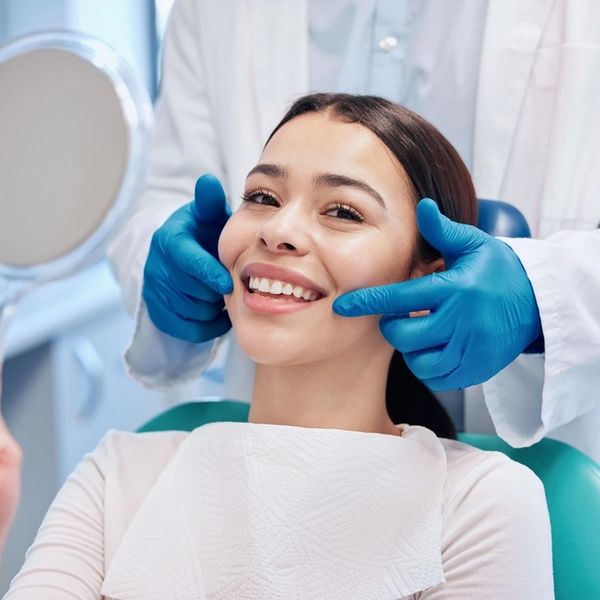 Dentist, mirror and portrait of woman with smile after teeth whitening, service and dental care