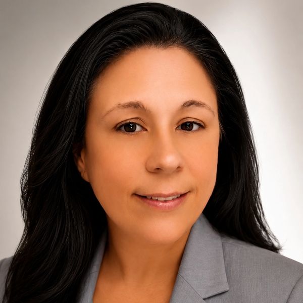 Professional portrait of a woman with long dark hair.