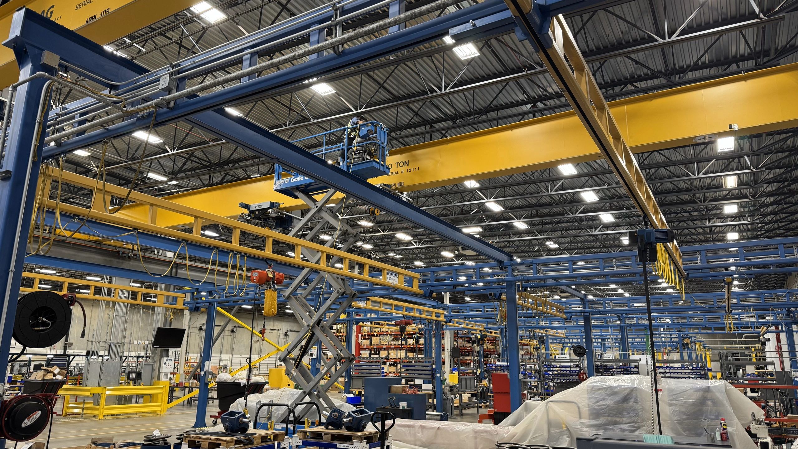 WDCleaning technician performing high dusting in an industrial warehouse in Houston, Texas.