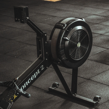 Black Concept 2 rowing machine on gym floor.
