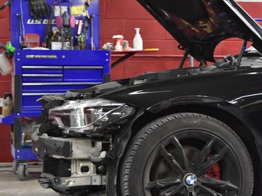 Black BMW in BMC Auto Collision Inc. shop