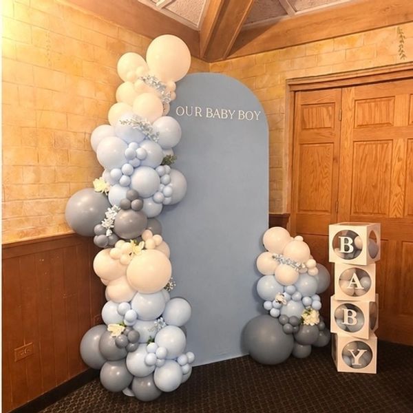 Baby boy themed party backdrop with balloons and blocks.