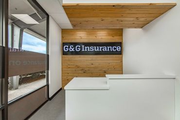 Reception area of G&amp;G Insurance with modern wooden wall design.