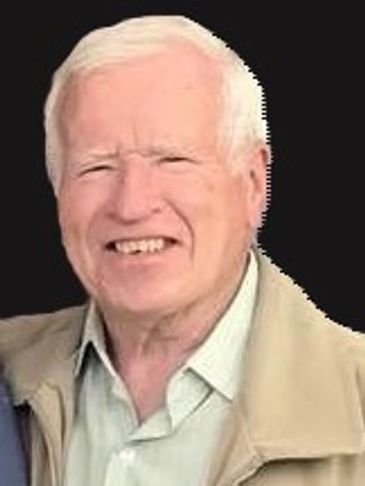 Smiling elderly man with white hair against a black background.