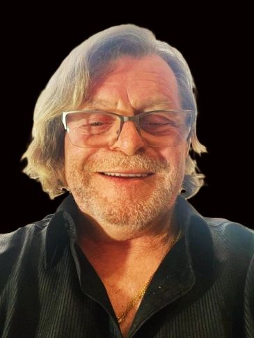 Smiling older man with glasses and gray hair.