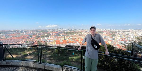 A handsome young man overlooking Lisbon Portugal.