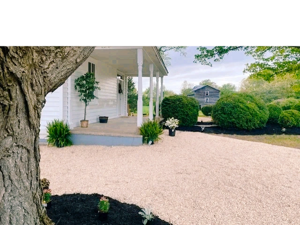 Fresh landscaping of the wedding venues rustic front yard.