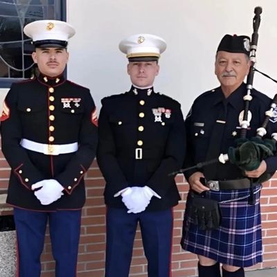 alt="Veteran bagpiper performing at a military funeral"