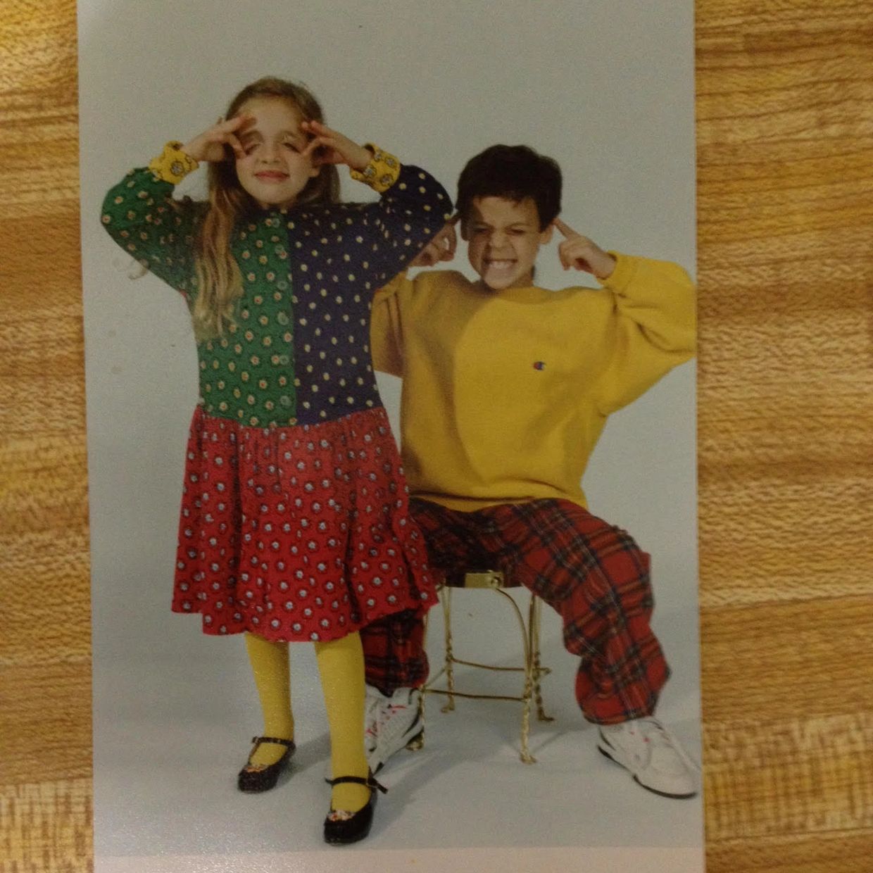 Two children making funny faces and gestures.